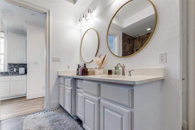 1652 Norfolk St Unit A, Houston, TX 77006 - bathroom with tile patterned flooring, double vanity, and tasteful backsplash