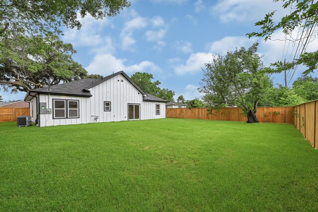 5731 Belvedere St, Houston, TX 77021 - rear view of house with board and batten siding, central AC unit, and a shingled roof