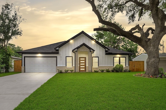 5731 Belvedere St, Houston, TX 77021 - view of front of home featuring brick siding, concrete driveway, a garage, and board and batten siding