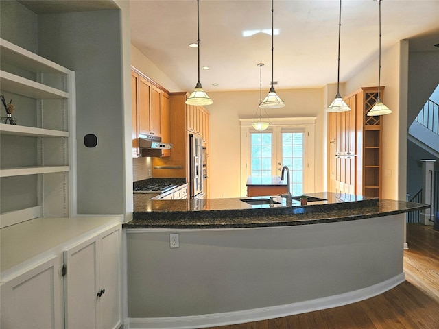 3818 Hazard St, Houston, TX 77098 - kitchen with a sink, under cabinet range hood, dark wood-type flooring, stainless steel gas cooktop, and hanging light fixtures