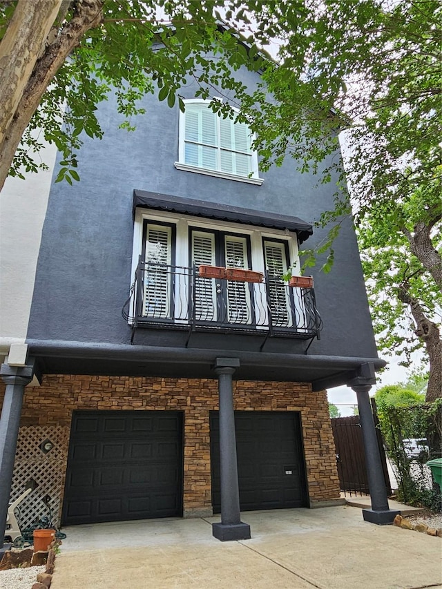 3818 Hazard St, Houston, TX 77098 - view of front of property featuring an attached garage, a balcony, stucco siding, and driveway