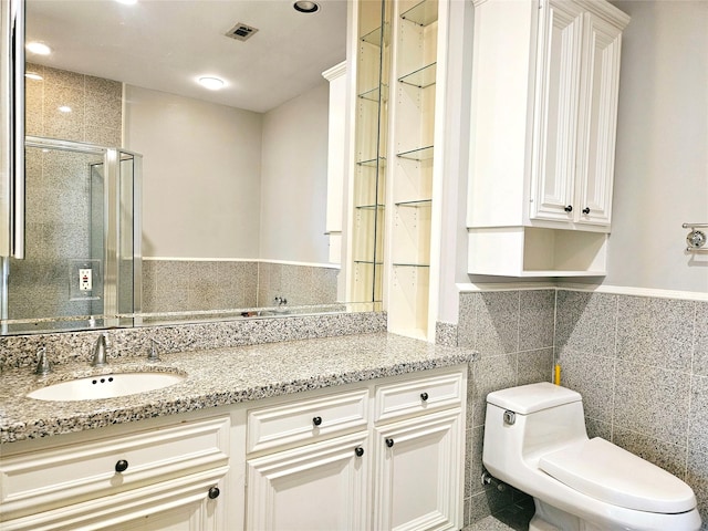 3818 Hazard St, Houston, TX 77098 - full bath featuring a shower stall, toilet, tile walls, vanity, and recessed lighting