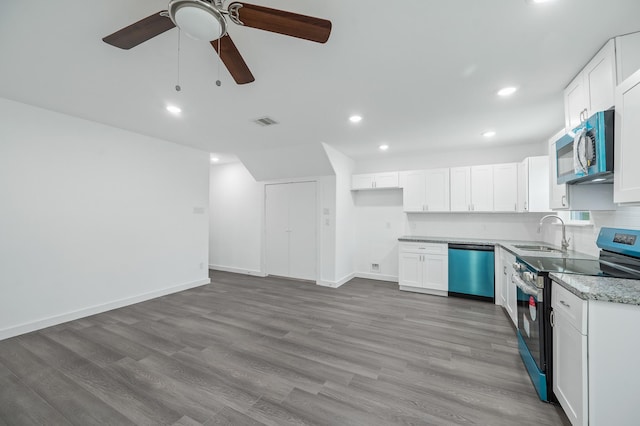 2322 Wavell St, Houston, TX 77088 - kitchen featuring stainless steel appliances, a sink, ceiling fan, white cabinets, and light wood-style floors