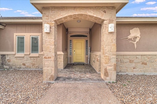 property entrance featuring stone siding