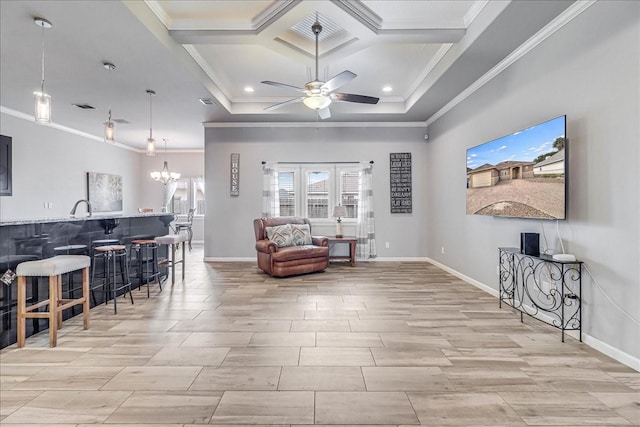 living area featuring a ceiling fan, coffered ceiling, crown molding, baseboards, and a chandelier