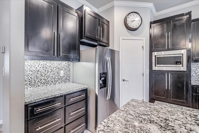 kitchen with appliances with stainless steel finishes, ornamental molding, decorative backsplash, and light stone countertops