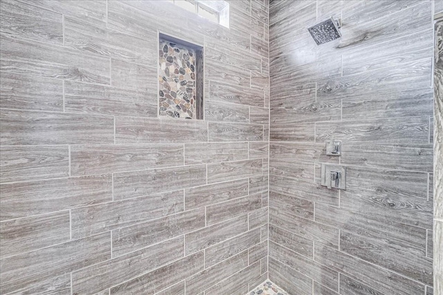 bathroom with a tile shower