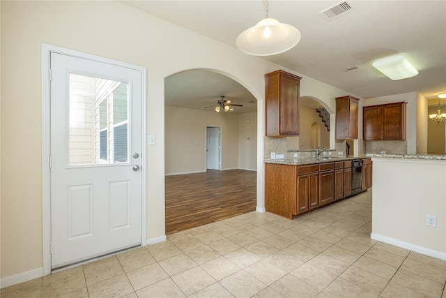 8919 Inglebrook Ln, Houston, TX 77083 - kitchen with arched walkways, dishwasher, ceiling fan, and baseboards