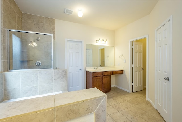 8919 Inglebrook Ln, Houston, TX 77083 - bathroom with a tile shower, tile patterned floors, vanity, and baseboards