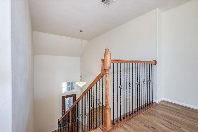 8919 Inglebrook Ln, Houston, TX 77083 - staircase featuring wood finished floors, baseboards, a chandelier, and vaulted ceiling