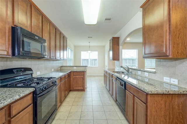 8919 Inglebrook Ln, Houston, TX 77083 - kitchen featuring black appliances, a sink, tasteful backsplash, and a peninsula