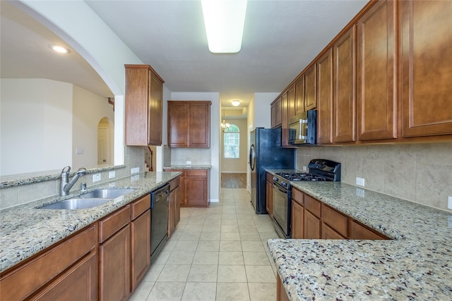 8919 Inglebrook Ln, Houston, TX 77083 - kitchen featuring black appliances, a sink, light stone counters, and tasteful backsplash
