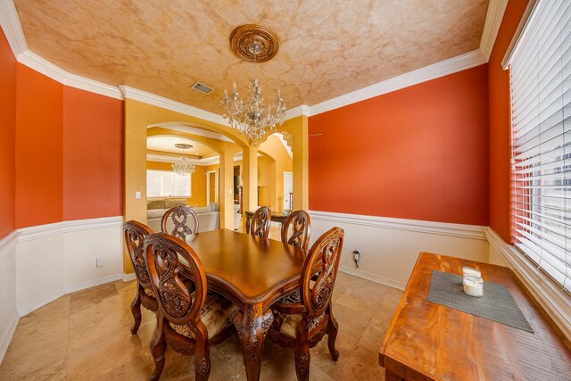 8606 Argentina St, Jersey Village, TX 77040 - tiled dining room featuring a chandelier, arched walkways, ornamental molding, and baseboards