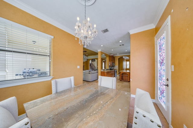 8606 Argentina St, Jersey Village, TX 77040 - dining space with ornamental molding, a chandelier, plenty of natural light, and decorative columns