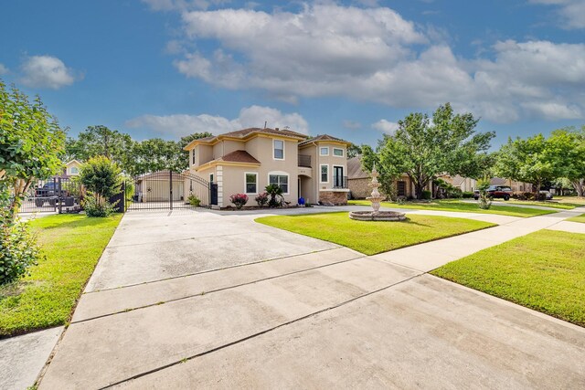 8606 Argentina St, Jersey Village, TX 77040 - mediterranean / spanish home featuring driveway, a front lawn, and stucco siding