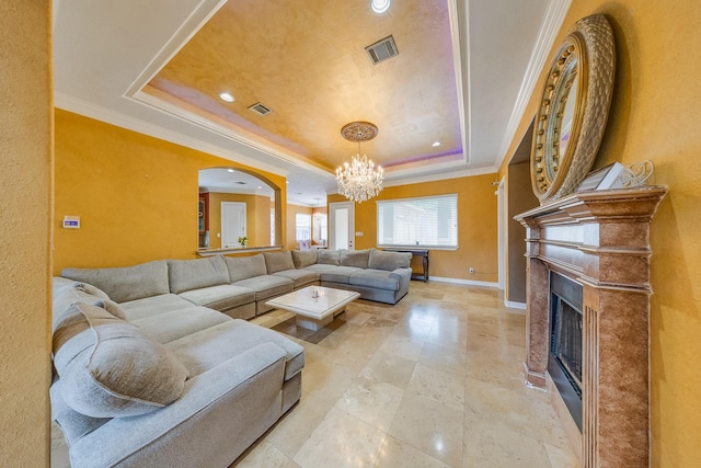 8606 Argentina St, Jersey Village, TX 77040 - living room with a tray ceiling, a chandelier, crown molding, a fireplace, and baseboards