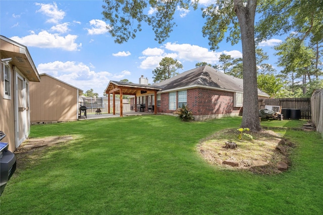 15703 W Astern Dr, Crosby, TX 77532 - rear view of property with a patio area, a chimney, and brick siding