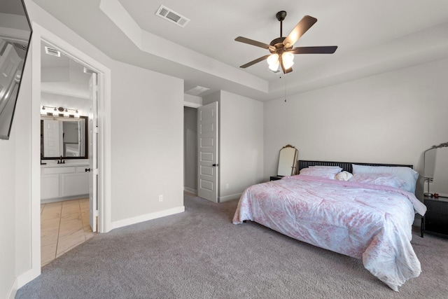 7010 Grassland Vista Ln, Katy, TX 77493 - bedroom featuring carpet floors, a raised ceiling, ensuite bath, and a ceiling fan