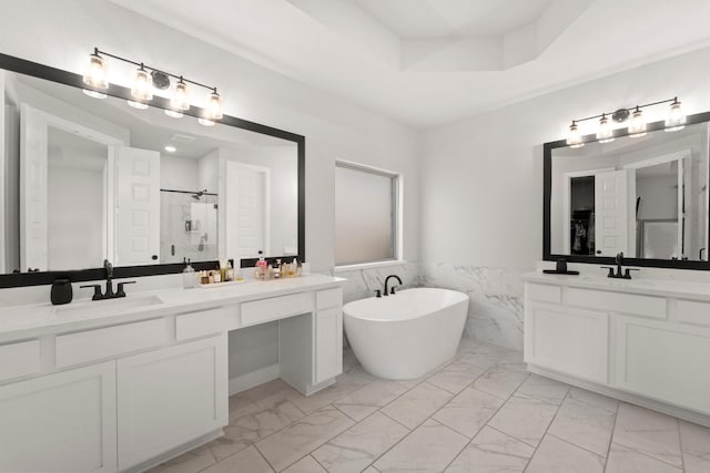 7010 Grassland Vista Ln, Katy, TX 77493 - full bath with marble finish floors, a stall shower, two vanities, a freestanding bath, and tile walls