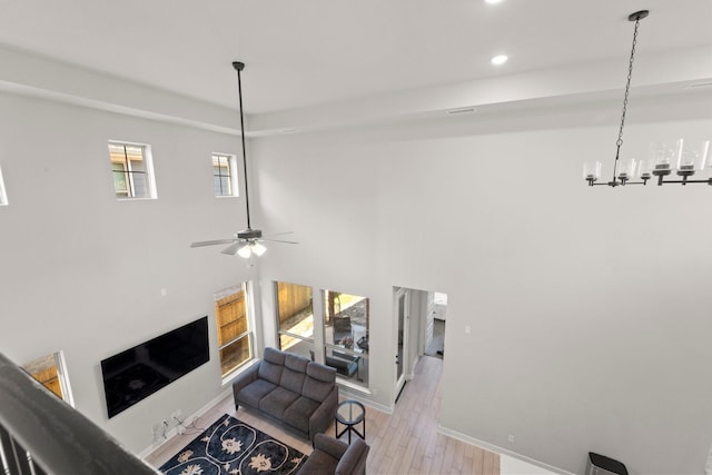 7010 Grassland Vista Ln, Katy, TX 77493 - living room featuring light wood-style flooring, recessed lighting, a chandelier, and a ceiling fan