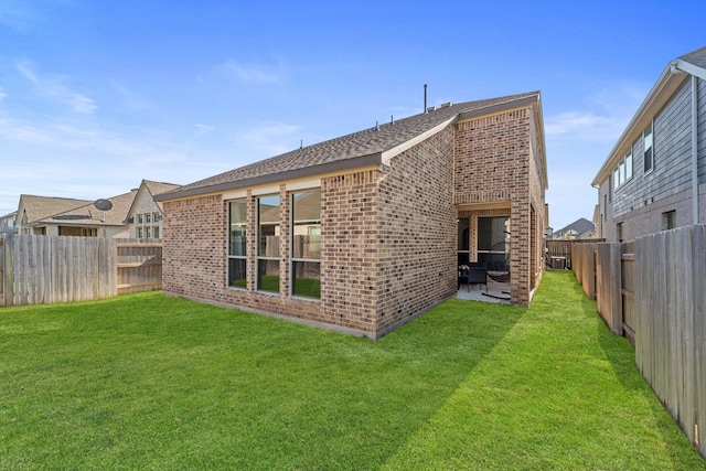 7010 Grassland Vista Ln, Katy, TX 77493 - rear view of property with brick siding, a fenced backyard, and a shingled roof