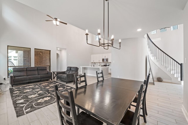 7010 Grassland Vista Ln, Katy, TX 77493 - dining space featuring ceiling fan, a high ceiling, stairway, a chandelier, and recessed lighting
