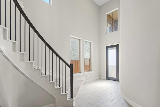 7010 Grassland Vista Ln, Katy, TX 77493 - entryway featuring a towering ceiling, stairway, and wood finished floors