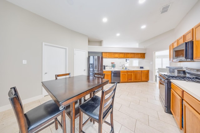 3610 Banks Run Ln, Katy, TX 77449 - kitchen featuring appliances with stainless steel finishes, a sink, light countertops, recessed lighting, and baseboards