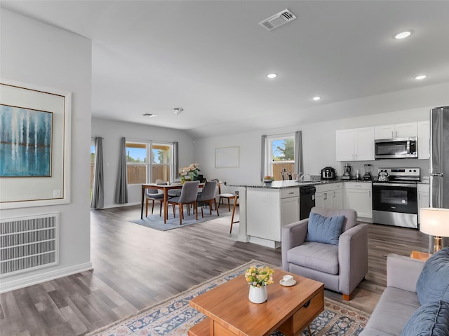 2715 Marguerite St, Bay City, TX 77414 - living area featuring healthy amount of natural light, wood finished floors, recessed lighting, and baseboards