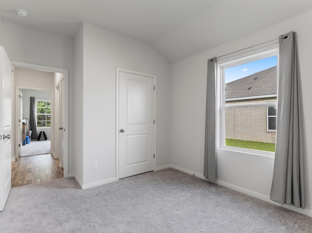 2715 Marguerite St, Bay City, TX 77414 - unfurnished bedroom featuring carpet, baseboards, and lofted ceiling