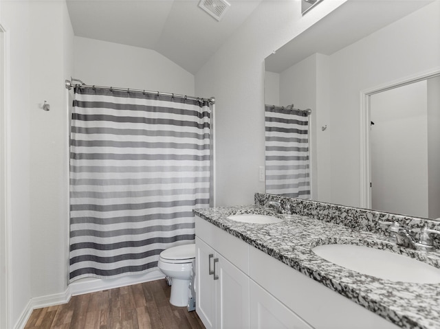 2715 Marguerite St, Bay City, TX 77414 - full bathroom with wood finished floors, toilet, double vanity, a shower with shower curtain, and lofted ceiling