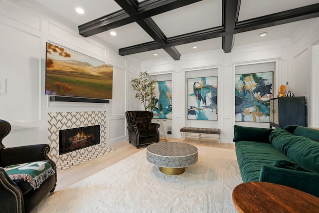 3702 Deerbend Ct, Spring, TX 77386 - living area featuring a decorative wall, wood finished floors, beamed ceiling, a tile fireplace, and coffered ceiling