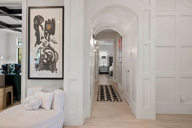 3702 Deerbend Ct, Spring, TX 77386 - hallway with light wood-style floors, arched walkways, beamed ceiling, and coffered ceiling