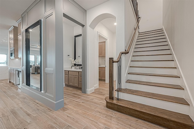 10615 Painted Crescent Ct, Cypress, TX 77433 - stairs featuring wood finished floors and arched walkways