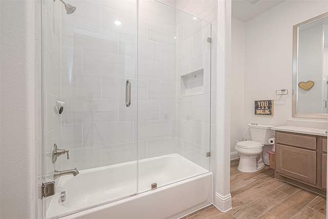 10615 Painted Crescent Ct, Cypress, TX 77433 - full bathroom featuring toilet, bath / shower combo with glass door, wood finished floors, vanity, and baseboards