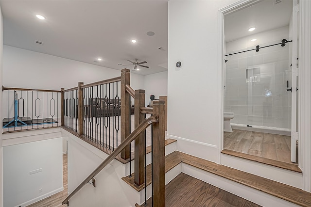 10615 Painted Crescent Ct, Cypress, TX 77433 - stairway featuring wood finished floors, a ceiling fan, baseboards, and recessed lighting