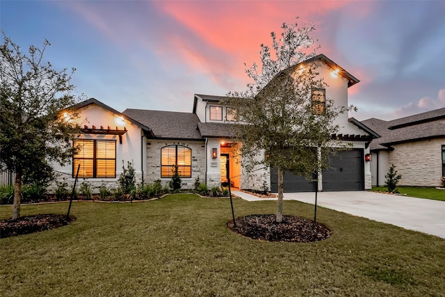 10615 Painted Crescent Ct, Cypress, TX 77433 - view of front of home featuring stone siding, concrete driveway, a yard, a shingled roof, and stucco siding