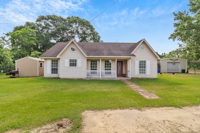11664 Fm 92, Silsbee, TX 77656 - ranch-style house with covered porch, an outdoor structure, a front yard, and roof with shingles
