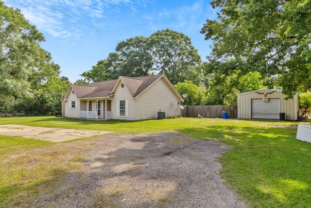 11664 Fm 92, Silsbee, TX 77656 - view of front of property with driveway, an outbuilding, a detached garage, and cooling unit