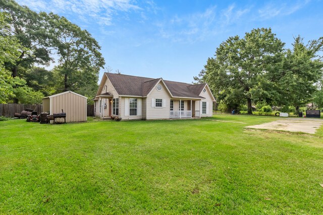 11664 Fm 92, Silsbee, TX 77656 - view of property exterior featuring a porch, a shed, and an outbuilding