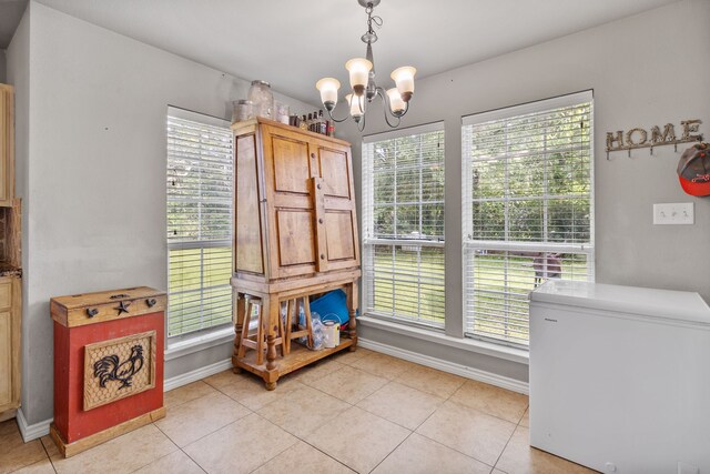11664 Fm 92, Silsbee, TX 77656 - unfurnished dining area with a chandelier, baseboards, and plenty of natural light