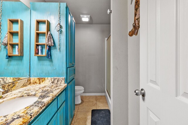 11664 Fm 92, Silsbee, TX 77656 - full bath with toilet, vanity, tile patterned floors, a shower stall, and baseboards