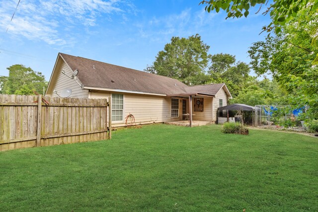 11664 Fm 92, Silsbee, TX 77656 - rear view of house with a patio and roof with shingles