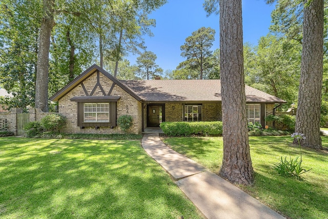 234 Willowbend St, Huntsville, TX 77320 - english style home featuring brick siding, roof with shingles, and a chimney