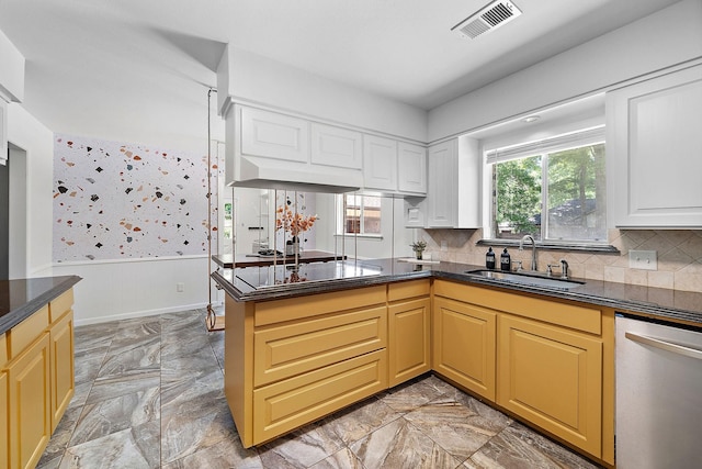 234 Willowbend St, Huntsville, TX 77320 - kitchen featuring stainless steel dishwasher, a sink, dark countertops, a peninsula, and wainscoting