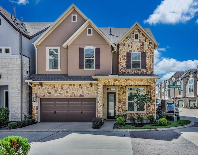11015 Ayrshire Park Ln, Houston, TX 77043 - view of front facade featuring stone siding, driveway, an attached garage, stucco siding, and a shingled roof