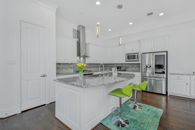 11015 Ayrshire Park Ln, Houston, TX 77043 - kitchen with stainless steel appliances, a sink, wall chimney range hood, white cabinets, and dark wood-type flooring