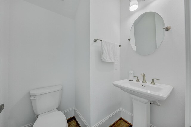 11015 Ayrshire Park Ln, Houston, TX 77043 - half bath featuring toilet, baseboards, wood finished floors, and a sink