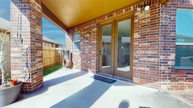 2702 Skyview Moon Dr, Houston, TX 77047 - entrance to property with brick siding, fence, a patio, and french doors