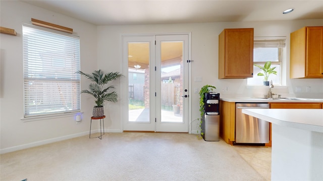 2702 Skyview Moon Dr, Houston, TX 77047 - kitchen with stainless steel dishwasher, a sink, light countertops, and plenty of natural light